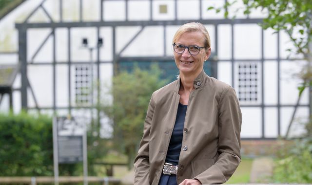 Eine Frau lächelt in die Kamera.